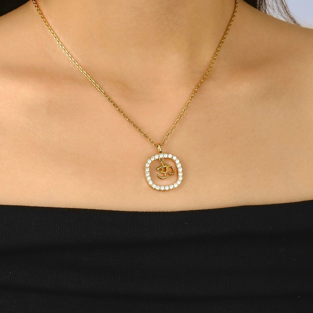 gold om diamond necklace