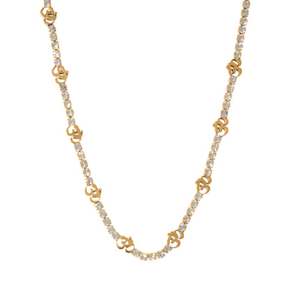 A gold-colored tennis necklace with zircon stones and an Om symbol in the center.