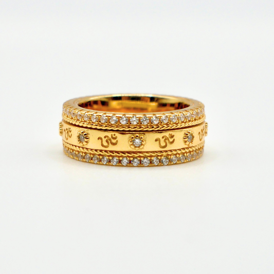Gold ring with diamond accents on a white background