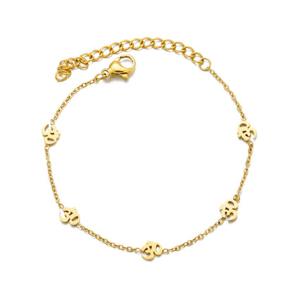 Gold bracelet with small chain links on a white background